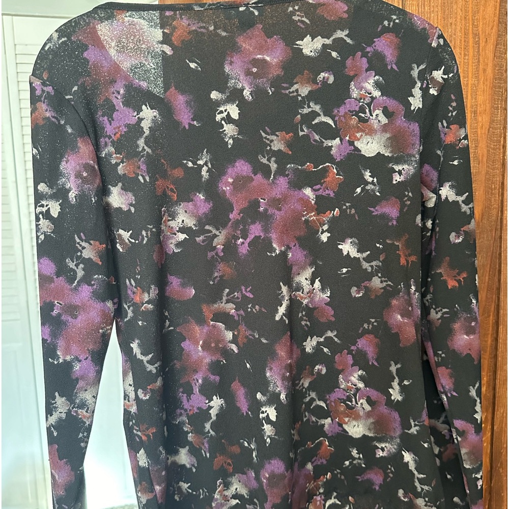 Beautiful polyester top with slight ruffle on bottom hem and sleeves.